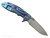 Rick Hinderer Knives XM-18 3.25" Spanto folding knife with thumb stud and flipper tab - shown open lock side.  Stonewashed MagnaCut stainless steel plain edge blade.  Black G-10 handle with stonewashed blue lock side.  Model KXM325SPA.