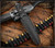 RMJ Tactical Nightshade Dagger - in sheath obverse shown.  Tungsten Cerakote 3V steel plain edge blade.  Black G-10 handle scales.  Model K-NS-3V-TU-BK.