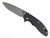 Rick Hinderer Knives XM-18 3.5" Spear Point folding knife with thumb stud and flipper tab - shown open presentation side.  Working Finish MagnaCut stainless steel plain edge blade.  Black G-10 handle with Battle Black lock side.  Model KXM35SPEDLC.