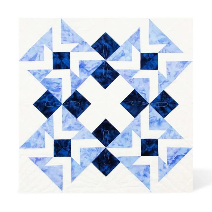 Blue and white geometric quilt pattern crafted by West Gosford sewing brand.