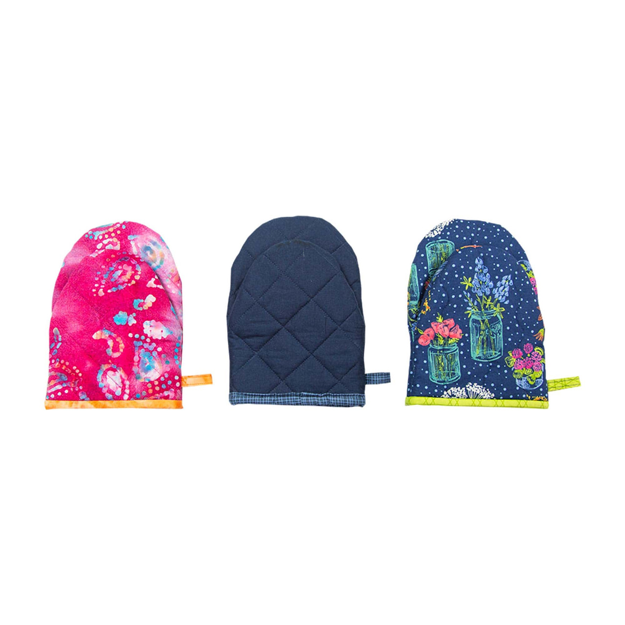 Three fabric cutting mitts featuring vibrant and patterned designs.