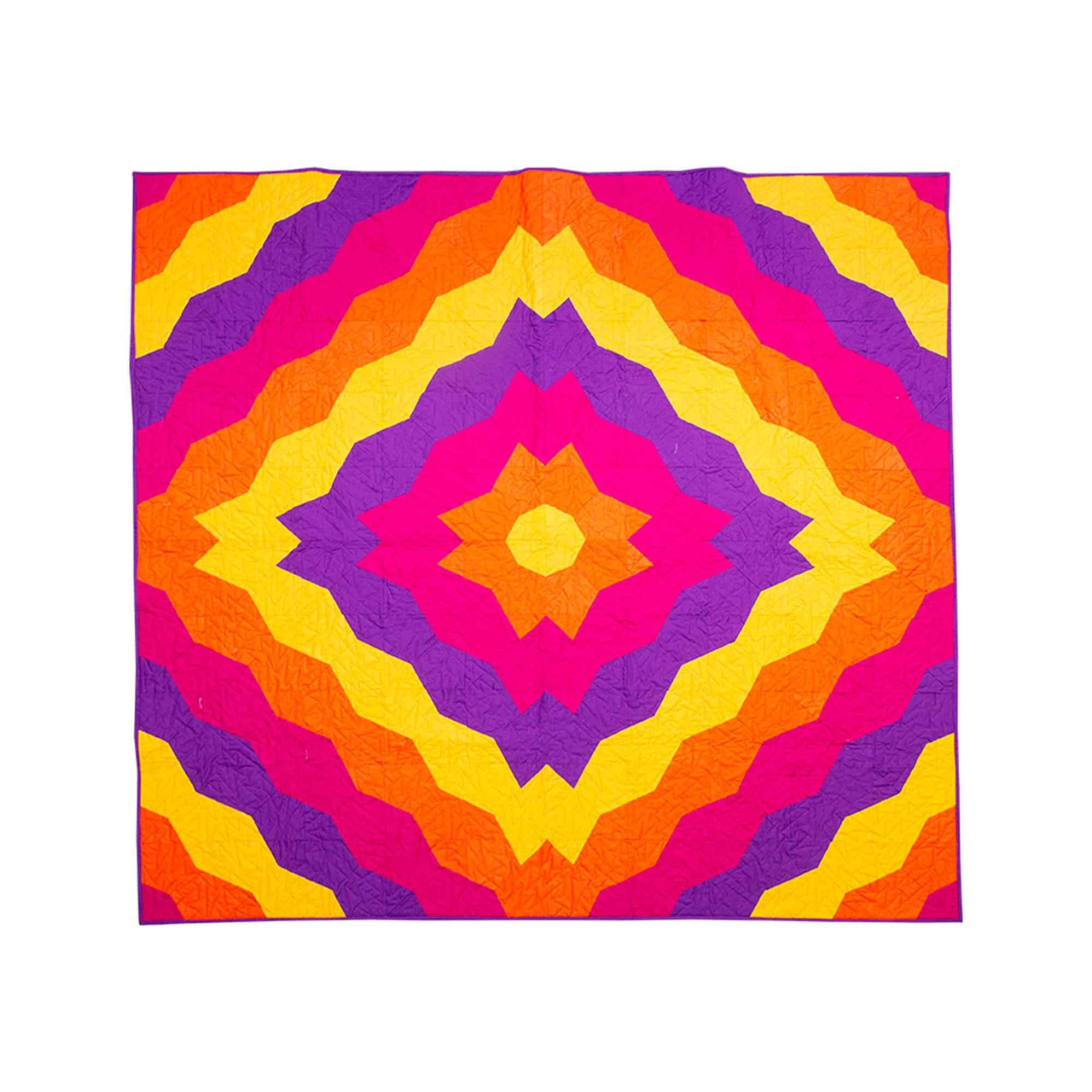 Colorful geometric quilt with vibrant orange pink yellow and purple patterns.
