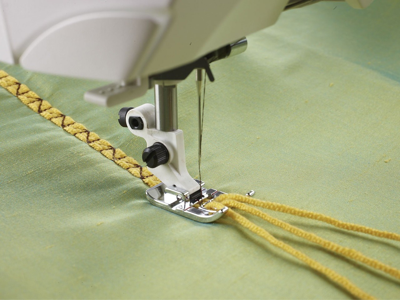 Three-hole yarn cording foot creating decorative stitches - Husqvarna Viking
