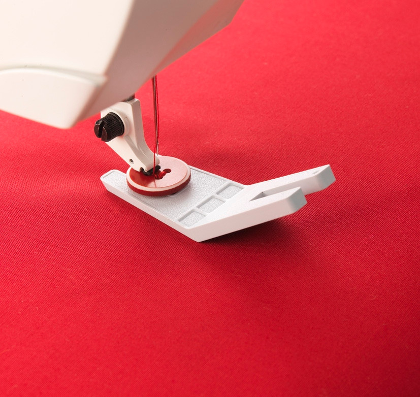 Sewing machine foot on red fabric for precision stitching in Lisarow NSW.