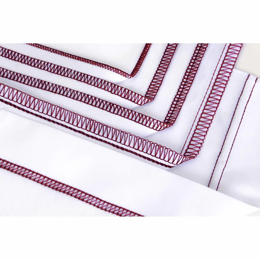 Close-up of white fabric with red serger stitching edges.