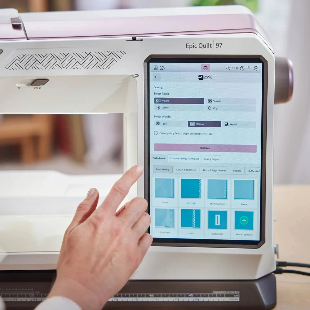 Person using a sewing machine touchscreen to select fabric options.