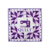 Purple quilt featuring geometric patterns and a sewing machine motif in the center.