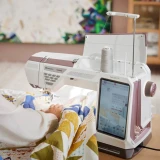 Sewing machine in use with colorful fabric ready for quilting.
