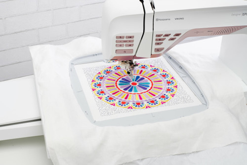 Husqvarna Viking embroidery machine stitching vibrant mandala hoop close up workspace