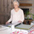 Quilter using a cutting machine in a cozy New South Wales sewing room.