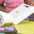 Quilting workspace showing the bolt catcher accessory in use with fabric rolls.