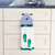 Decorative kitchen towel with blue stripes and green flip-flop design hanging neatly.