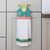Hanging fabric towel with colorful floral trim on a brass kitchen handle.