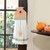 A decorative fabric towel with a spider design hangs on a door handle.