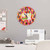 Sewing-themed clock and supplies in a fabric cutting workspace.