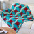Colorful geometric quilt draped over a white sofa in a cozy living room.
