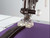 Invisible zipper presser foot for sewing machines, shown clearly on plain background