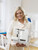 Woman holding Husqvarna Viking white serger overlocker machine - home sewing inspiration