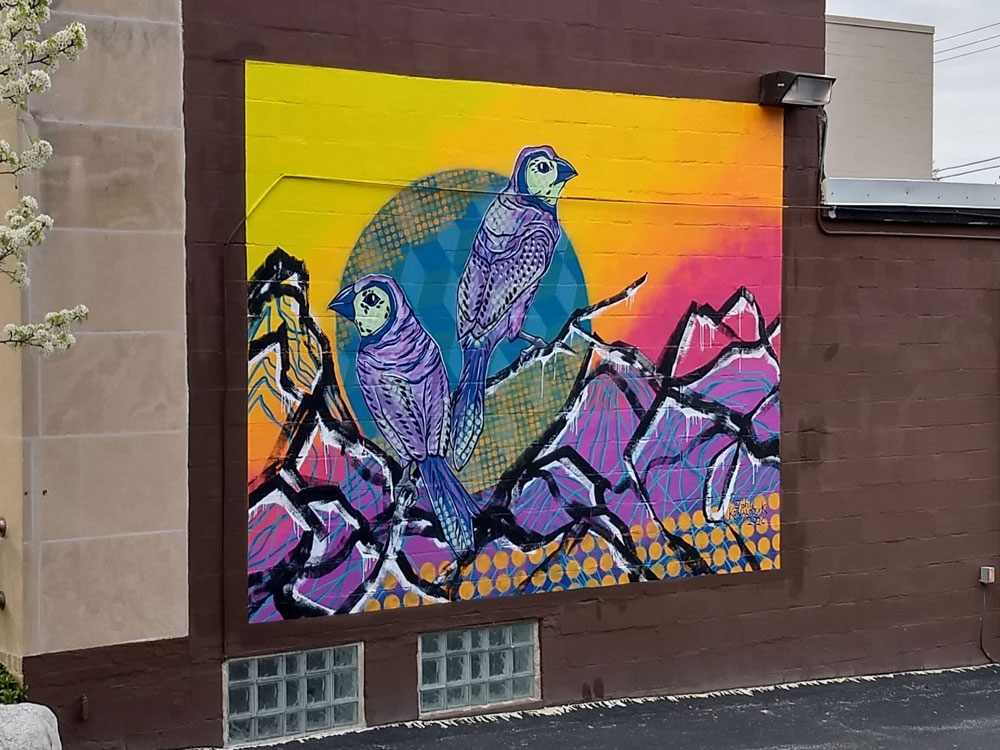 Mural of birds over mountains