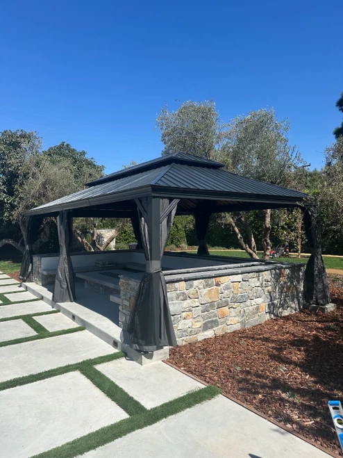 Domi Outdoor Living Hardtop Gazebo Brown with Drainage Gutters installed by a HandyBuddy expert in Downey, CA · Sep 2024