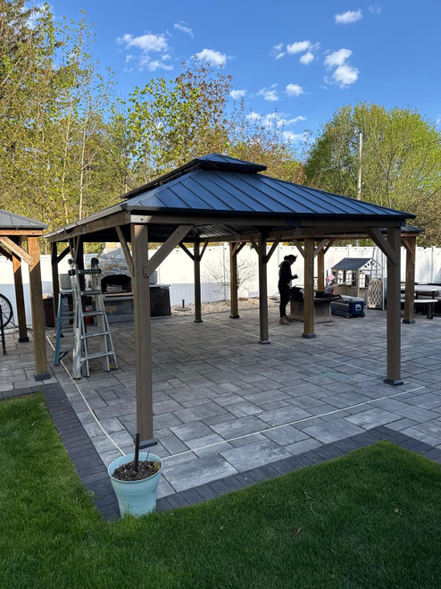 Domi Outdoor Living Hardtop Gazebo Brown with Drainage Gutters installed by a HandyBuddy expert in Woburn, MA · May 2026