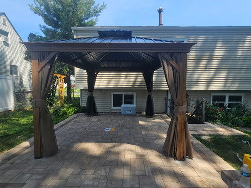 Domi Outdoor Living Hardtop Gazebo Brown with Drainage Gutters installed by a HandyBuddy expert in Port Jeff Sta, NY · Jun 2024