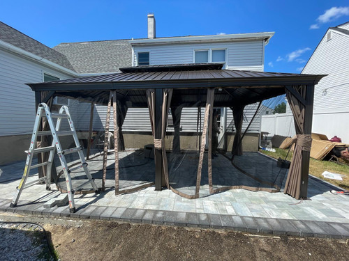 Domi Outdoor Living Hardtop Gazebo Brown with Drainage Gutters installed by a HandyBuddy expert in Freeport, NY · Jun 2024