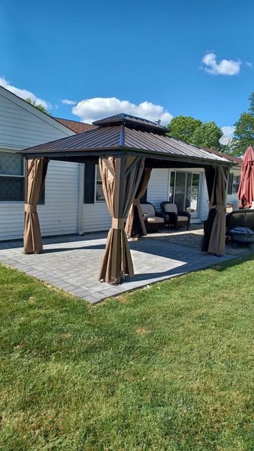 Domi Outdoor Living Hardtop Gazebo with Netting & Curtain installed by a HandyBuddy expert in Matawan, NJ · May 2024