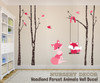 Pink mom and baby fox wall decals with dark birch trees, hanging swing, and pink birds for woodland nursery decor
