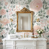 Olivia Rose Watercolor Wallpaper styled in a luxury bathroom with gold mirror, crystal sconces, white vanity, marble counter, and blush rose floral wall mural