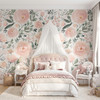 Olivia Rose Watercolor Wallpaper styled in a girls bedroom with canopy bed, pink tufted headboard, white bedding, and large blush rose wall mural