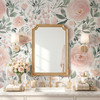 Olivia Rose Watercolor Wallpaper styled in a luxury bathroom with gold mirror, brass sconces, white vanity, marble counter, flowers, and blush pink rose wall mural