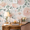Olivia Rose Watercolor Wallpaper styled with antique wood desk, table lamp, flowers, books, candle, and romantic pink rose wall decor