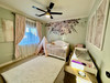 Wild Spring Garden floral wall decal border installed above a crib in a mint green nursery with window and ceiling fan