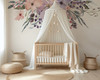 Wild Spring Garden floral wall decal with pink purple and blue watercolor flowers above a white canopy crib in a bright nursery