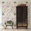 Willa cottage wildflower wallpaper in an entryway with a tall dark wood armoire and vintage bench, shown in the 52-inch repeat