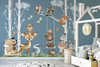 White birch trees and watercolor woodland animal wall decals displayed on a blue nursery wall beside a white house bed