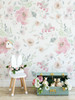 Watercolor flower wallpaper creating a whimsical girls playroom with blush floral accents