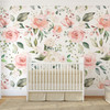 Emily Rose oversized pink watercolor rose wallpaper behind a white nursery crib