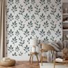 Blue green botanical leaf wallpaper in a home office with desk and chair, featuring the Fergus watercolor foliage design