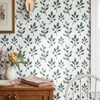 Fergus watercolor botanical wallpaper close-up in a cottage dining space with blue and sage green leafy branches