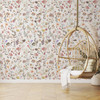 Beatrice Wildflower Wallpaper in a bright nursery with hanging wicker chair
