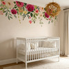 Jessica’s Farmhouse flower wall decal border installed above a white crib, featuring pink, burgundy and cream flowers with trailing greenery.