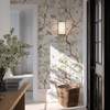 Selina vintage Chinoiserie wallpaper with birds and botanical branches in a sunlit entryway with black door and woven basket 78 repeat
