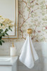 Close-up of Selina Chinoiserie wallpaper with vintage birds, delicate flowers, and green botanical branches beside a classic bathroom towel hook 26 repeat