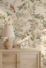 Close Up of Kelsey Beige Bird Wallpaper With Sage Leaves Above Nursery Dresser