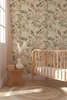 Kelsey Beige and Sage Bird Wallpaper in Warm Sunlit Nursery With Wood Crib