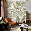 Detailed botanical wallpaper in a masculine living room with cognac leather and dark wood accents shown in the 26-inch scale