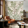 Oversized green and brown botanical wallpaper in a masculine living room with leather seating shown in the 78-inch scale