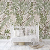 Neutral fern wallpaper in a bright nursery with a white crib and gray rocking horse